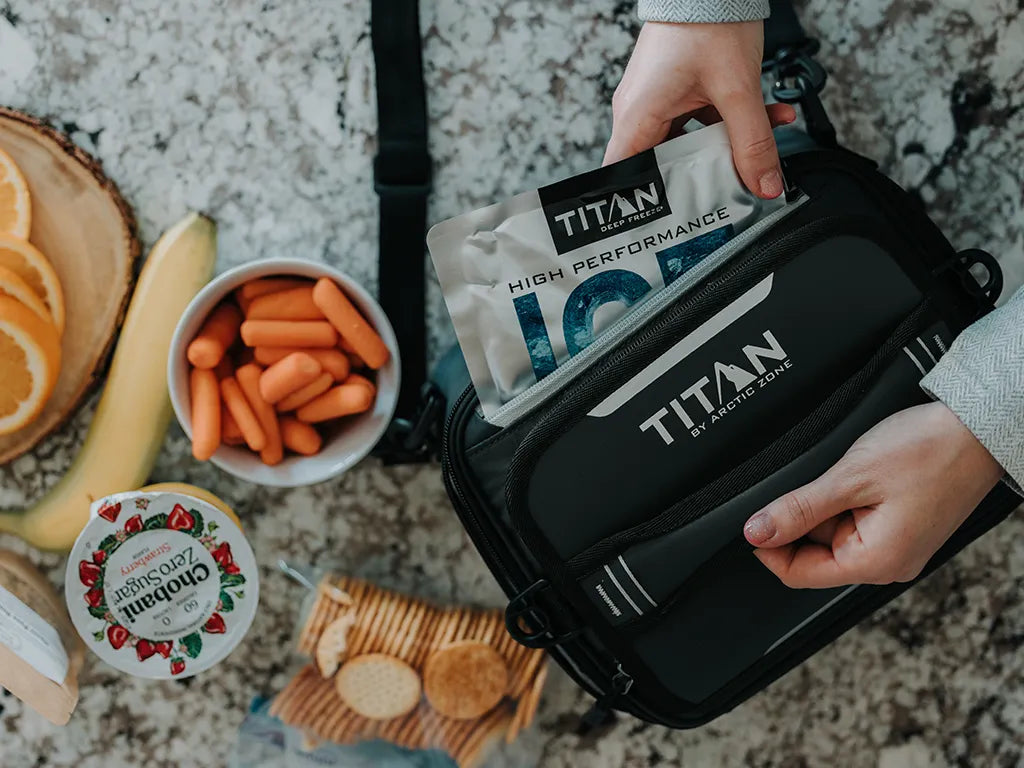 Person pulling an ice pack out of their Titan Lunch Box