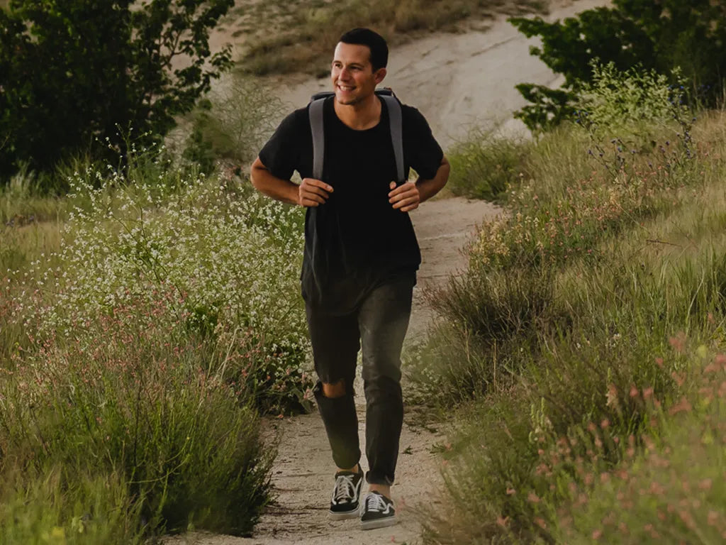 Guy walking with a Titan backpack cooler