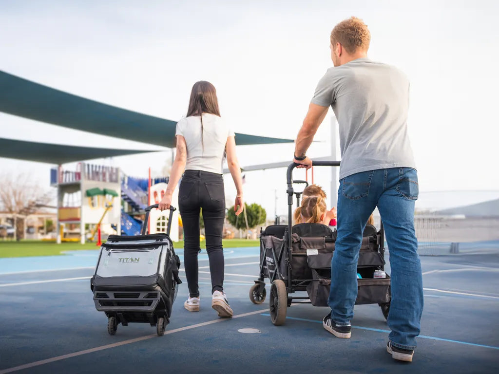 Family walking outside with a wagon and rolling cooler