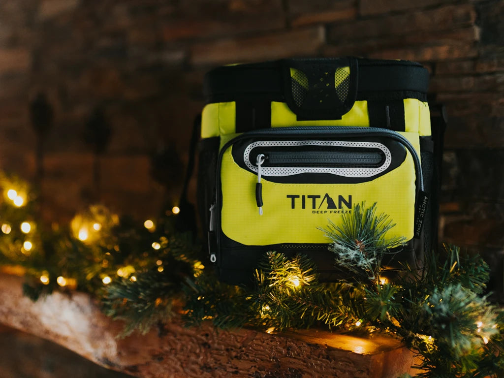 Titan 9 Can Zipperless Cooler on a fireplace mantle decorated with a holiday garland