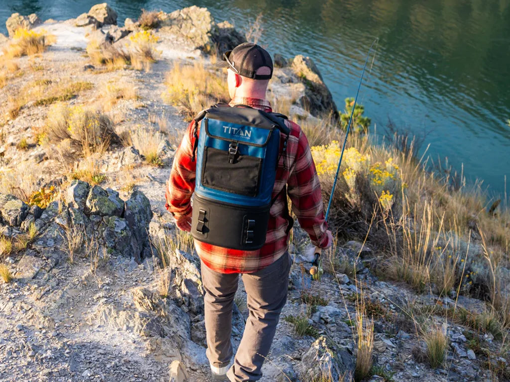 Man fishing while wearing a Titan Welded Backpack Cooler