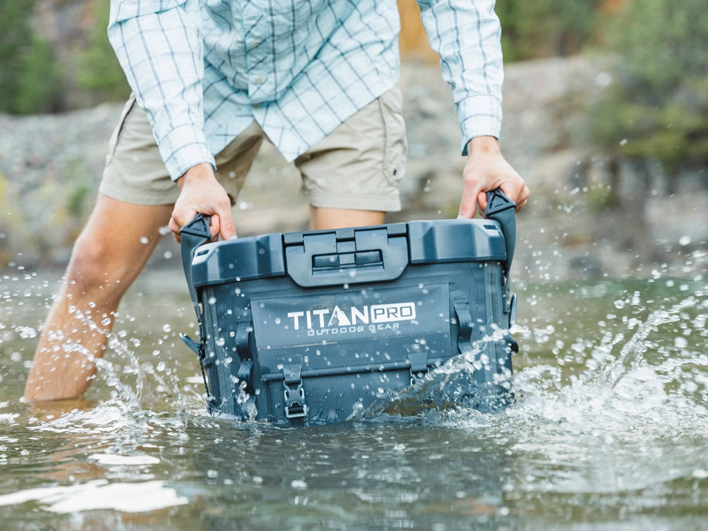 Man dunking a waterproof Titan PRO Welded Cooler in a lake