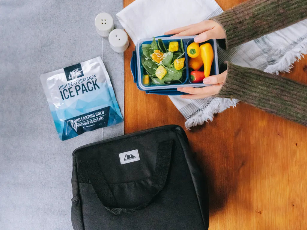 Person packing a salad in an Arctic Zone Meal Prep Lunch Bag