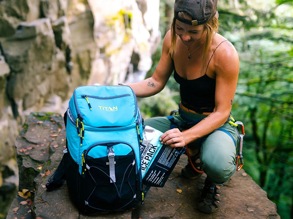 Lady pulling out Ice Walls from a Titan Backpack Cooler