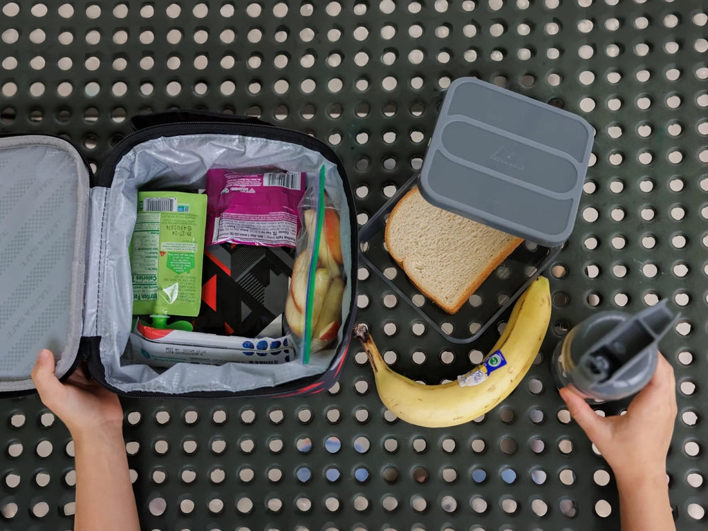 Arcitc Zone lunch bag filled with snacks on a picnic table