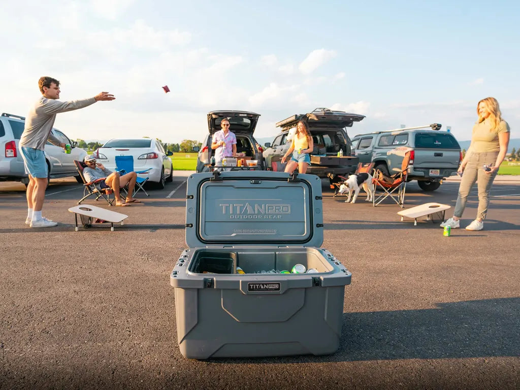 Group of friends playing cornhole at a tailgating party.