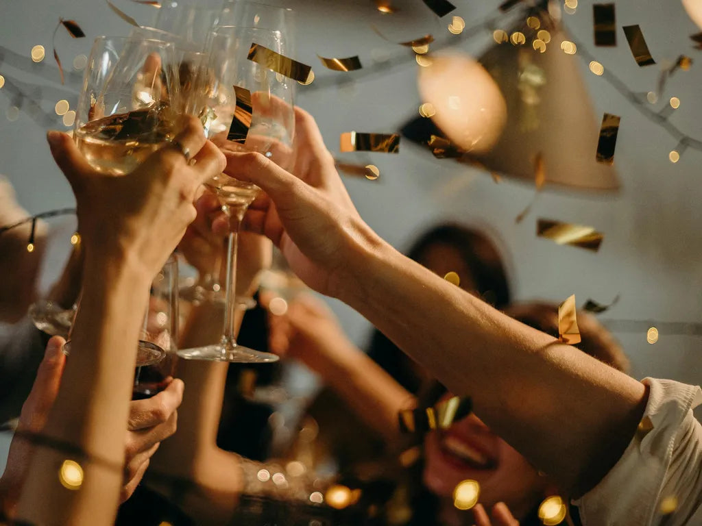 People holding up champagne glasses while celebrating New Years Eve