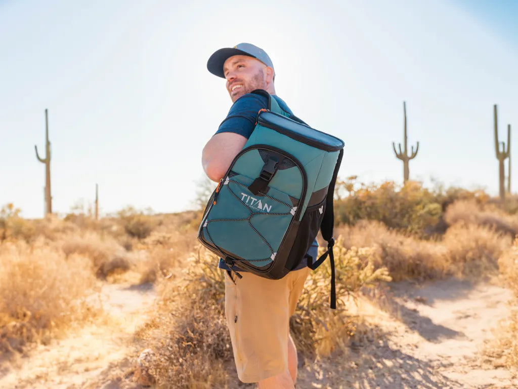 Guy hiking in Arizona wearing a Titan backpack cooler