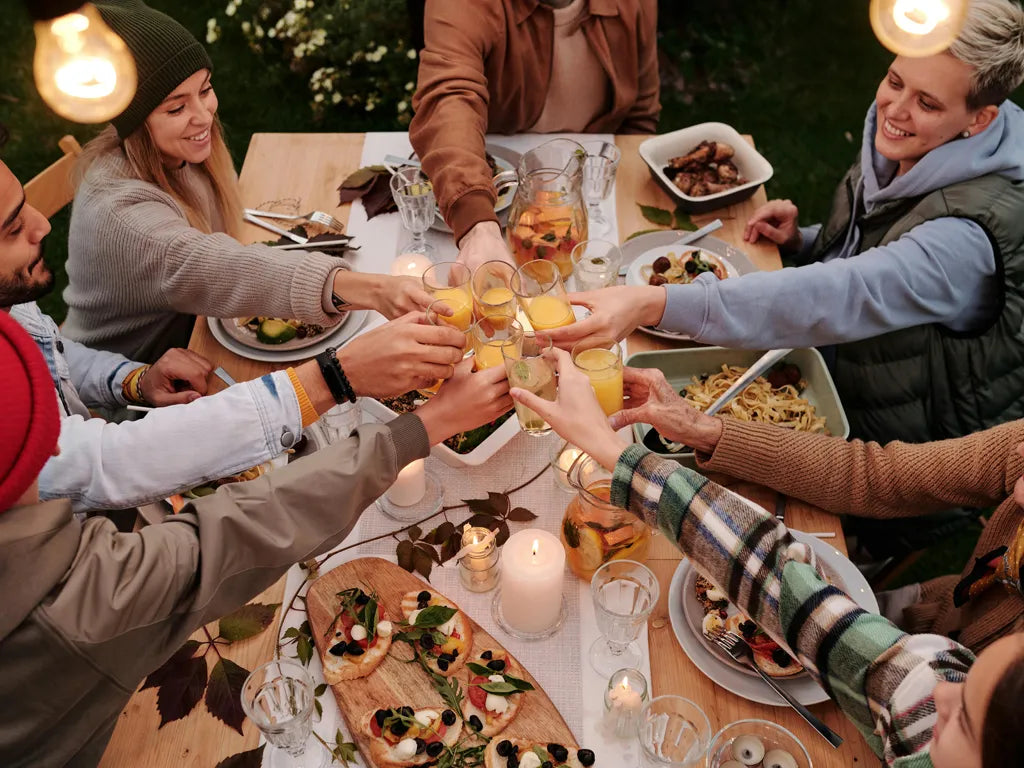 People giving cheers at a table for Thanksgiving