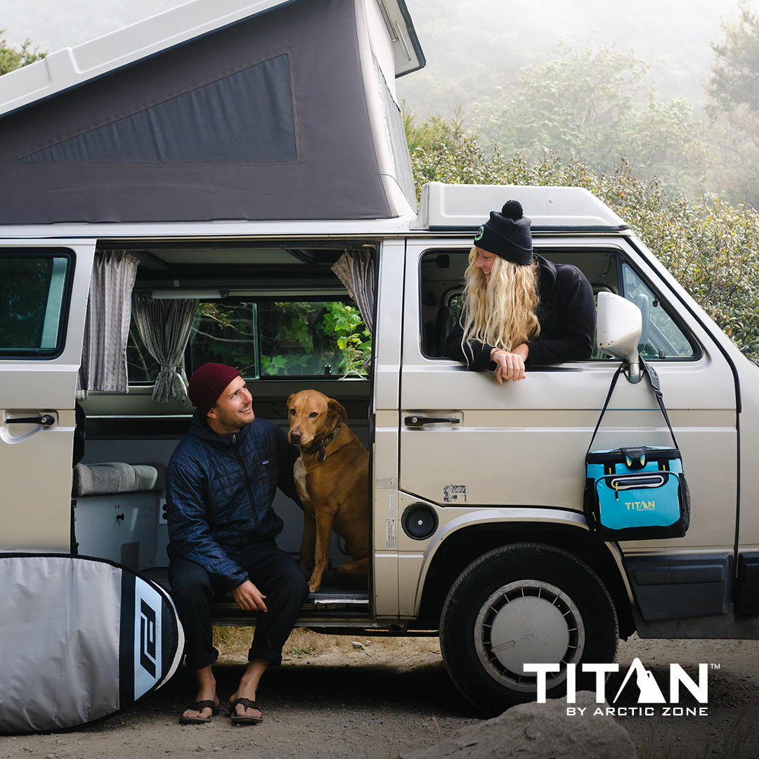 Couple with a dog and Titan Zipperless Cooler in a camper van