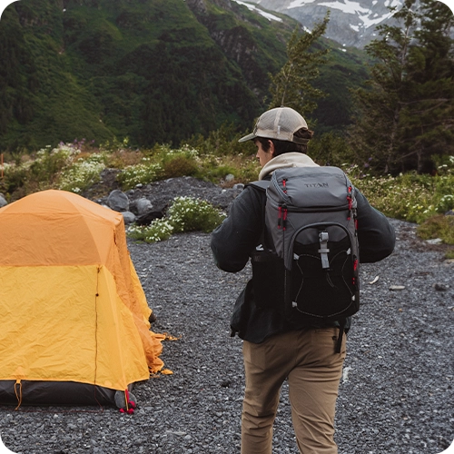 Guy wearing a Titan Backpack Cooler while camping