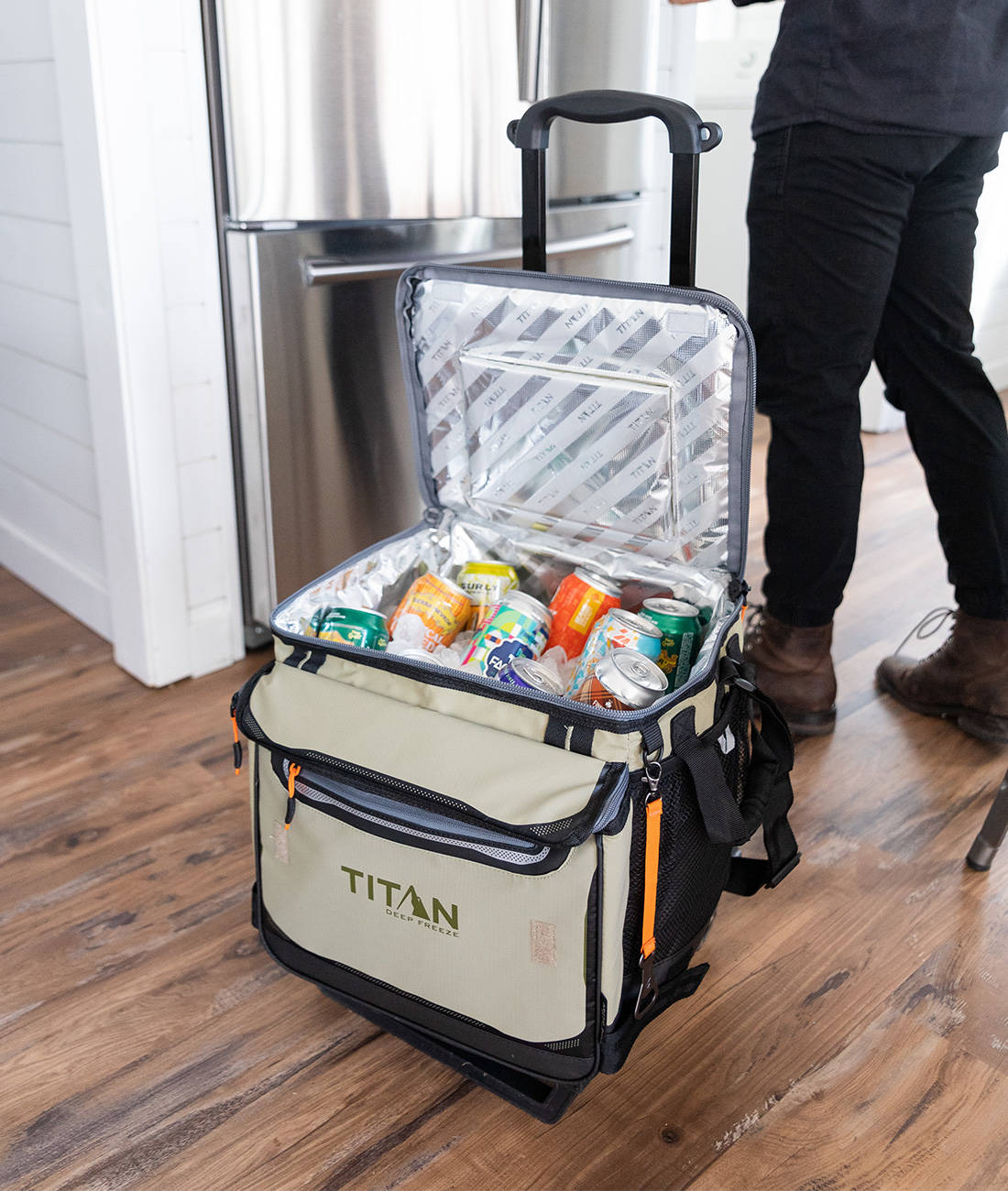 Titan by Arctic Zone 60 Can Wheeled Cooler full of cold drinks in a kitchen